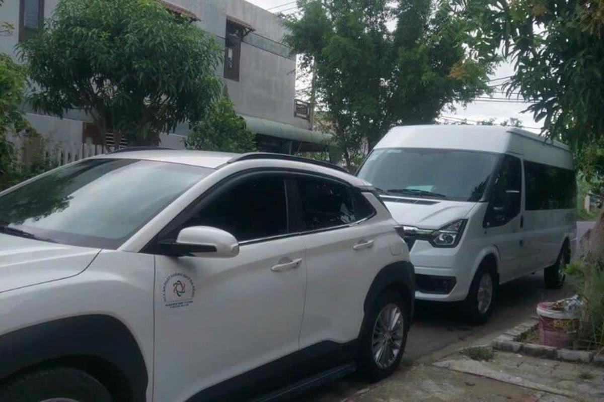 two white cars parked next to a white van