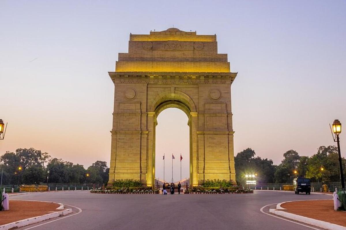 a large monument with an arch at dusk