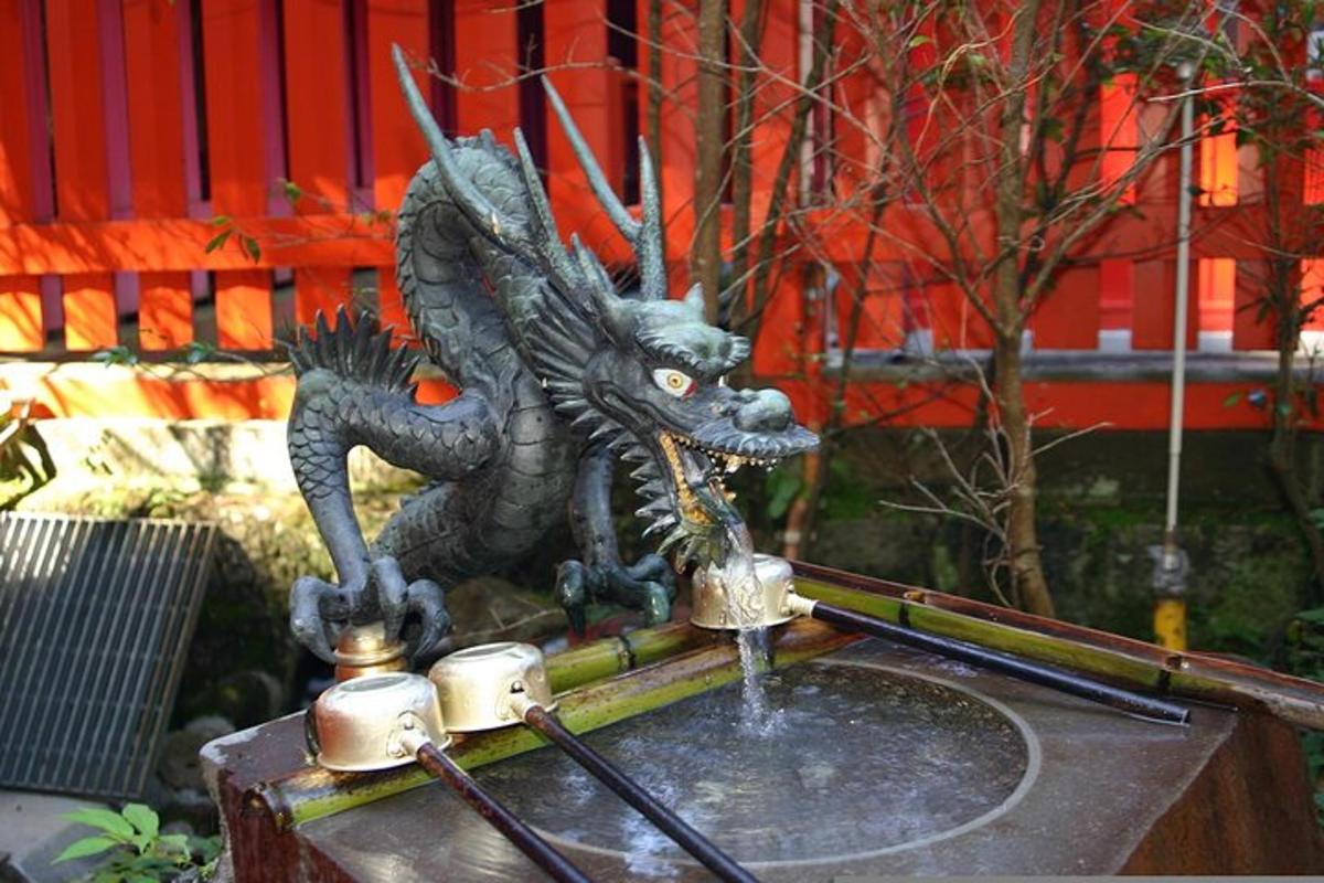 a statue of a dragon drinking from a fountain