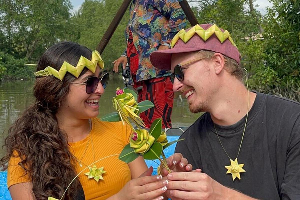 a man and a woman wearing crowns on a boat