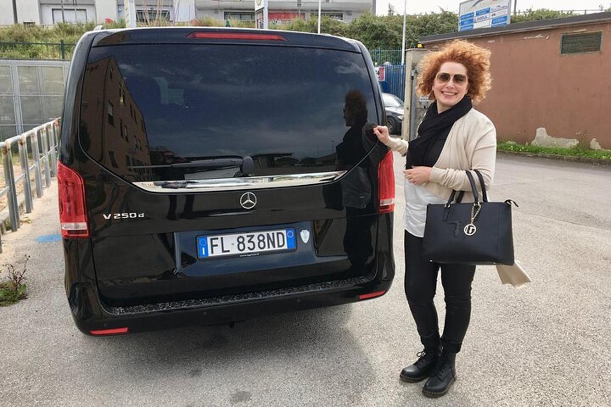 a woman standing in the open trunk of a car