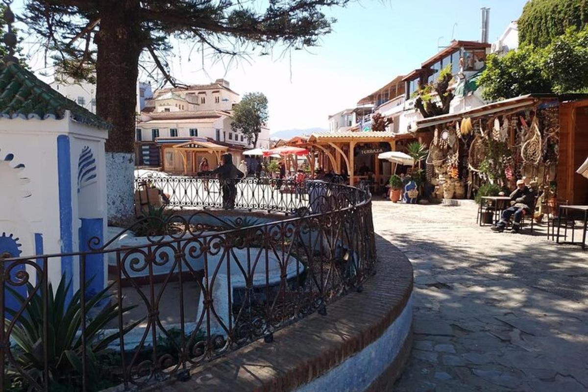 a city street with a fence in a town