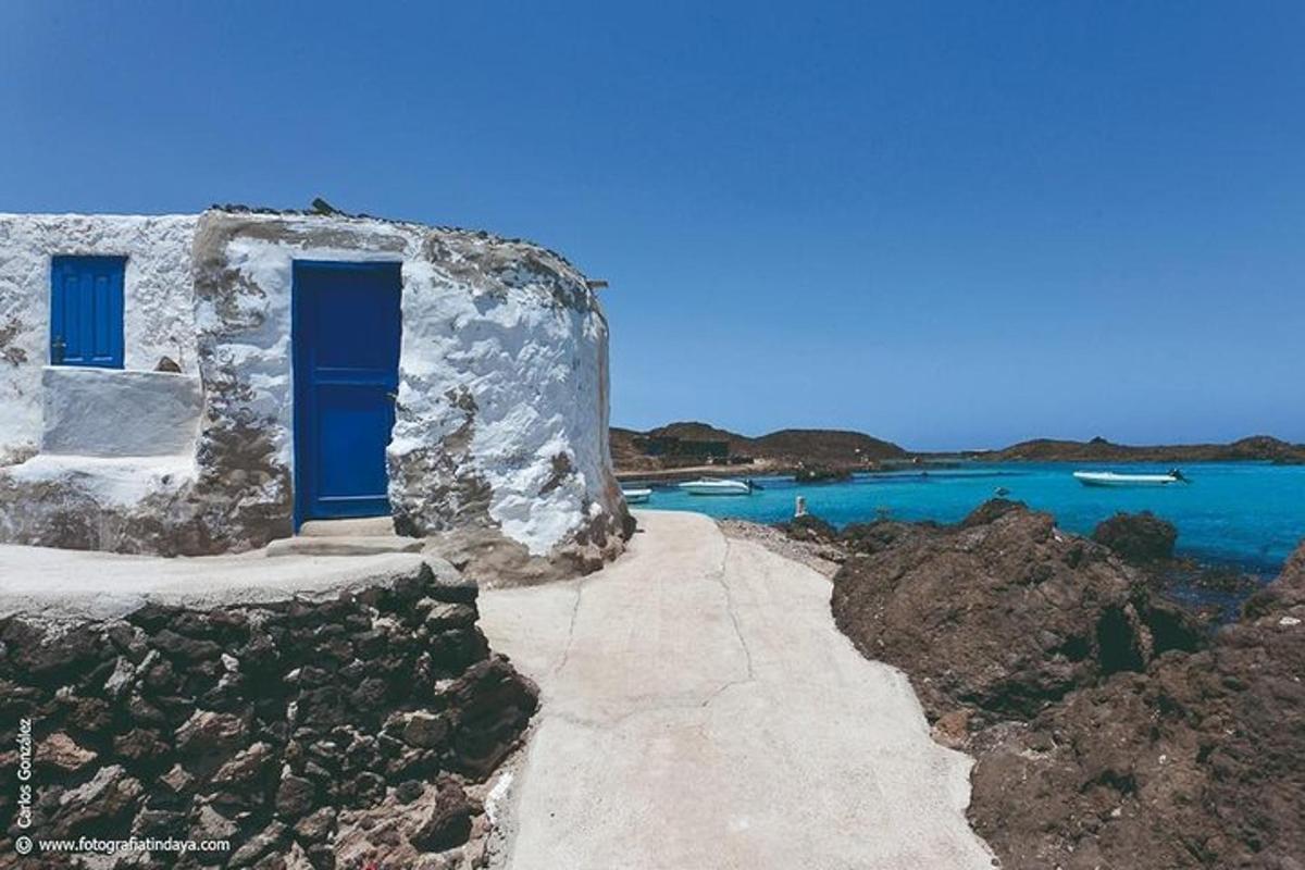 a blue door on a building next to the water