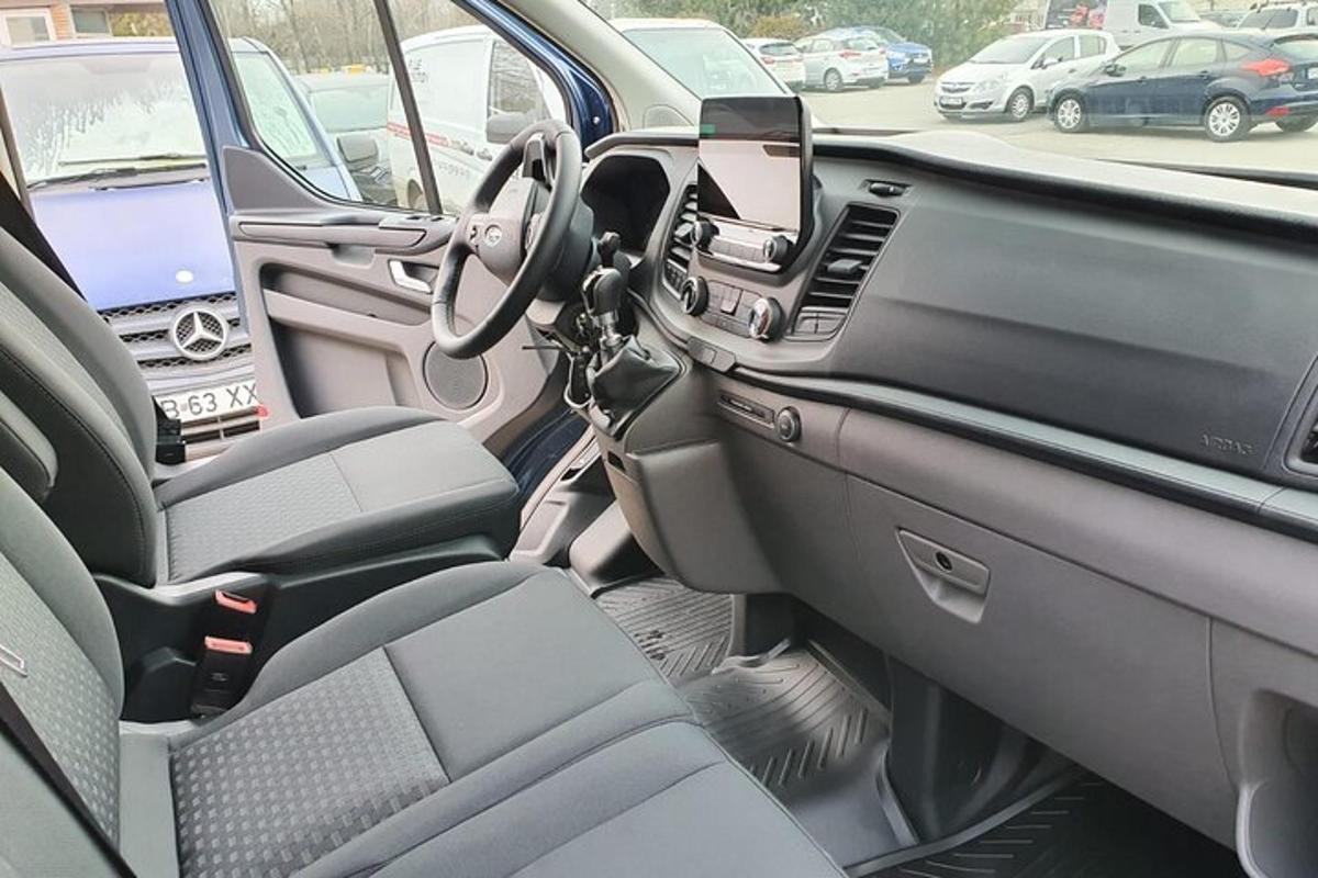 a car with the door open in a parking lot