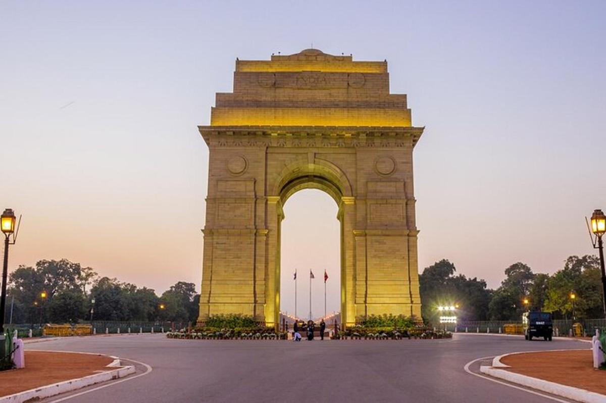 a large monument with an arch at dusk