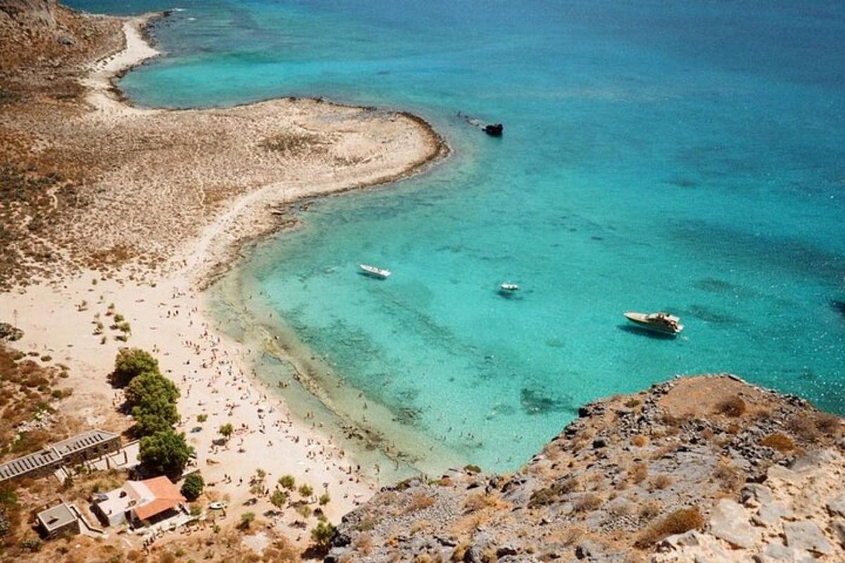 an aerial view of a beach with boats in the water