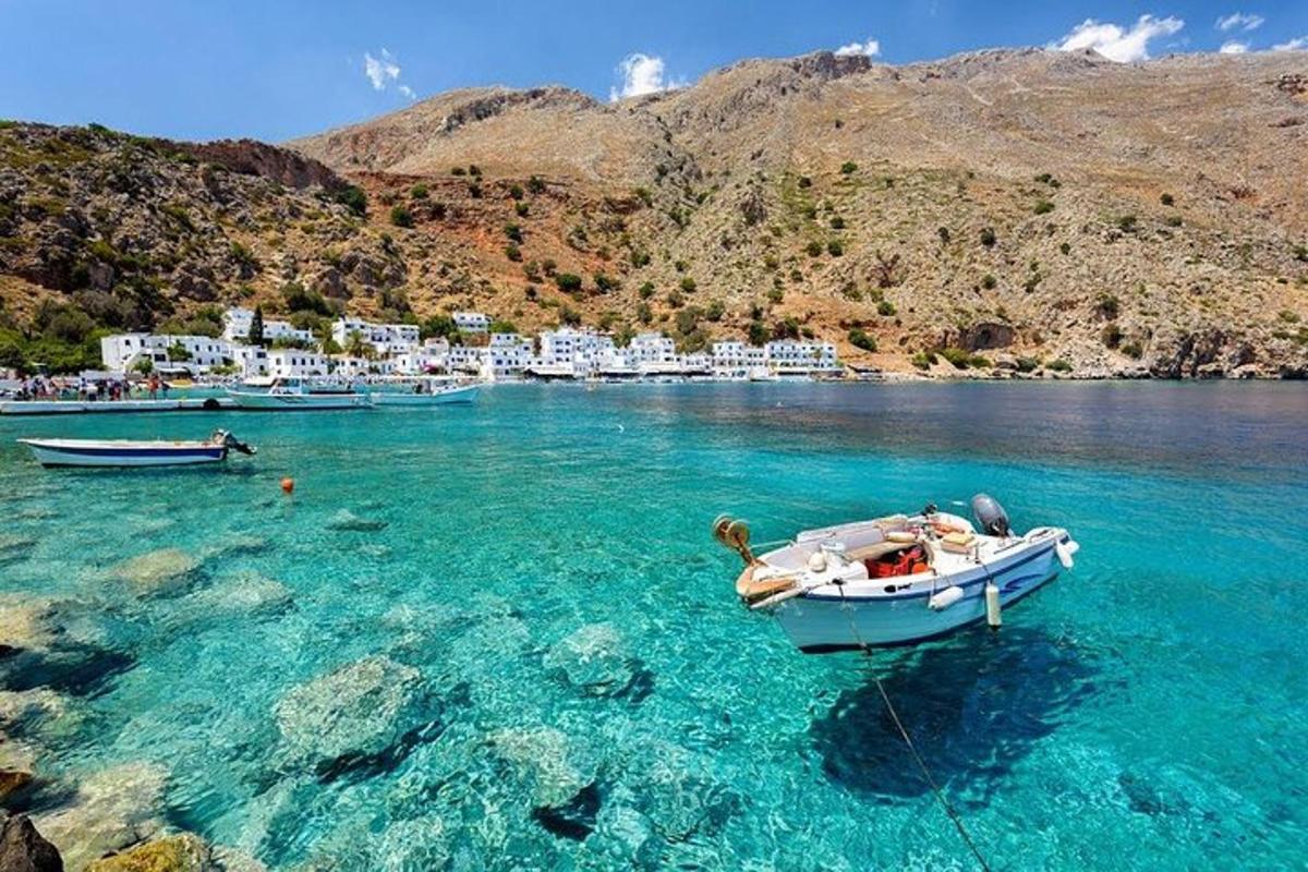 a group of boats in the water next to a beach