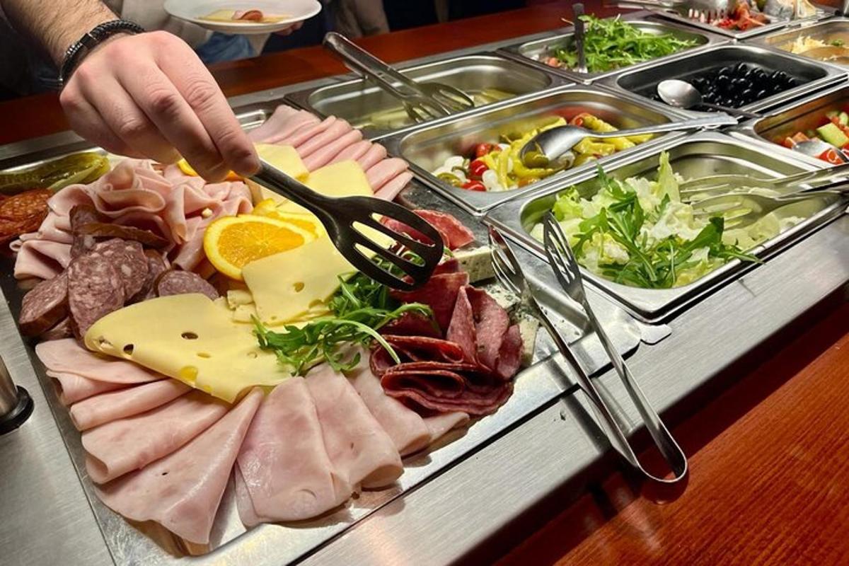 a tray of meats and cheese on a buffet