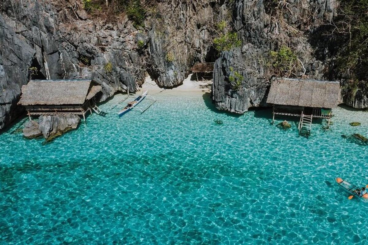 an image of a beach with rocks and blue water