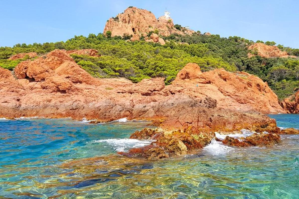 a rocky island in the ocean with a lighthouse on it