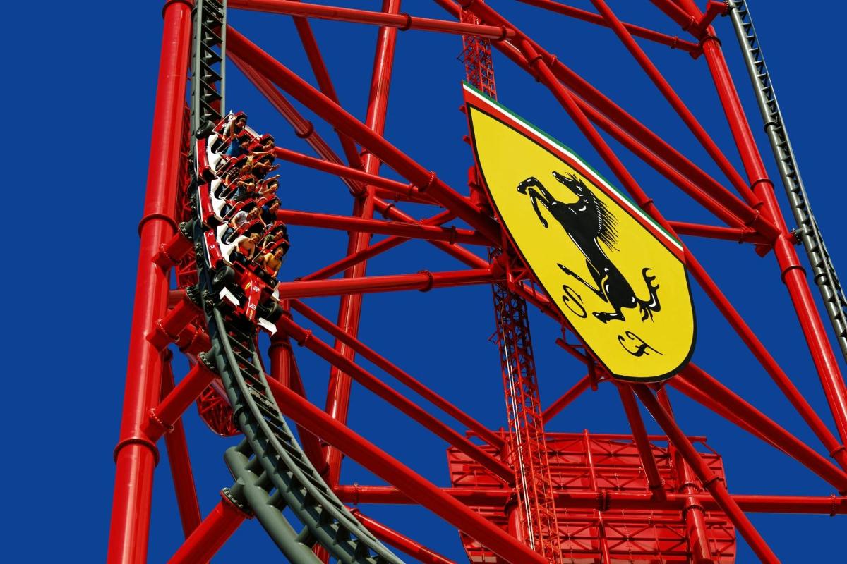 a yellow sign on a red ferris wheel