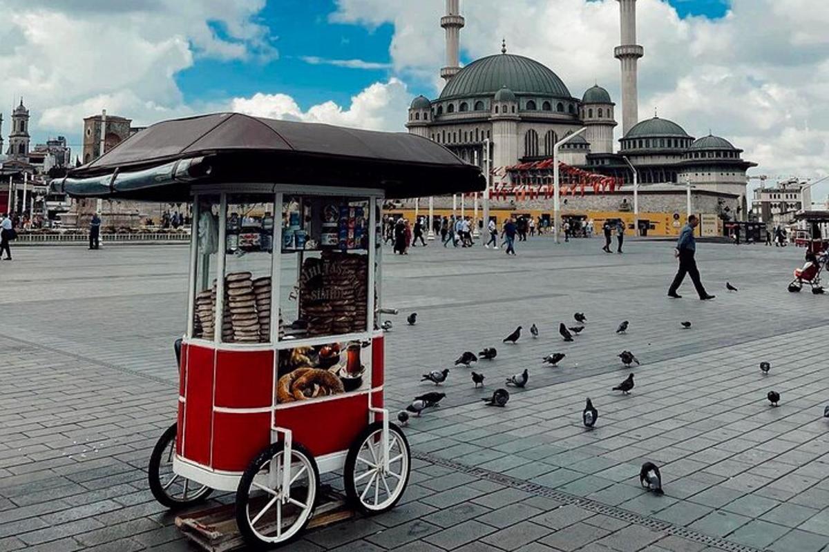 a food cart with a bunch of birds on the street