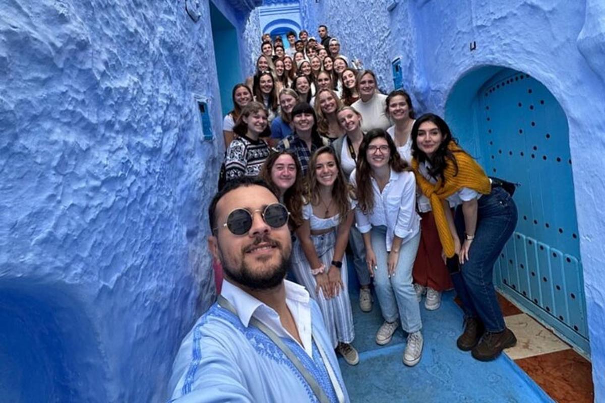a group of people posing for a picture in a blue tunnel