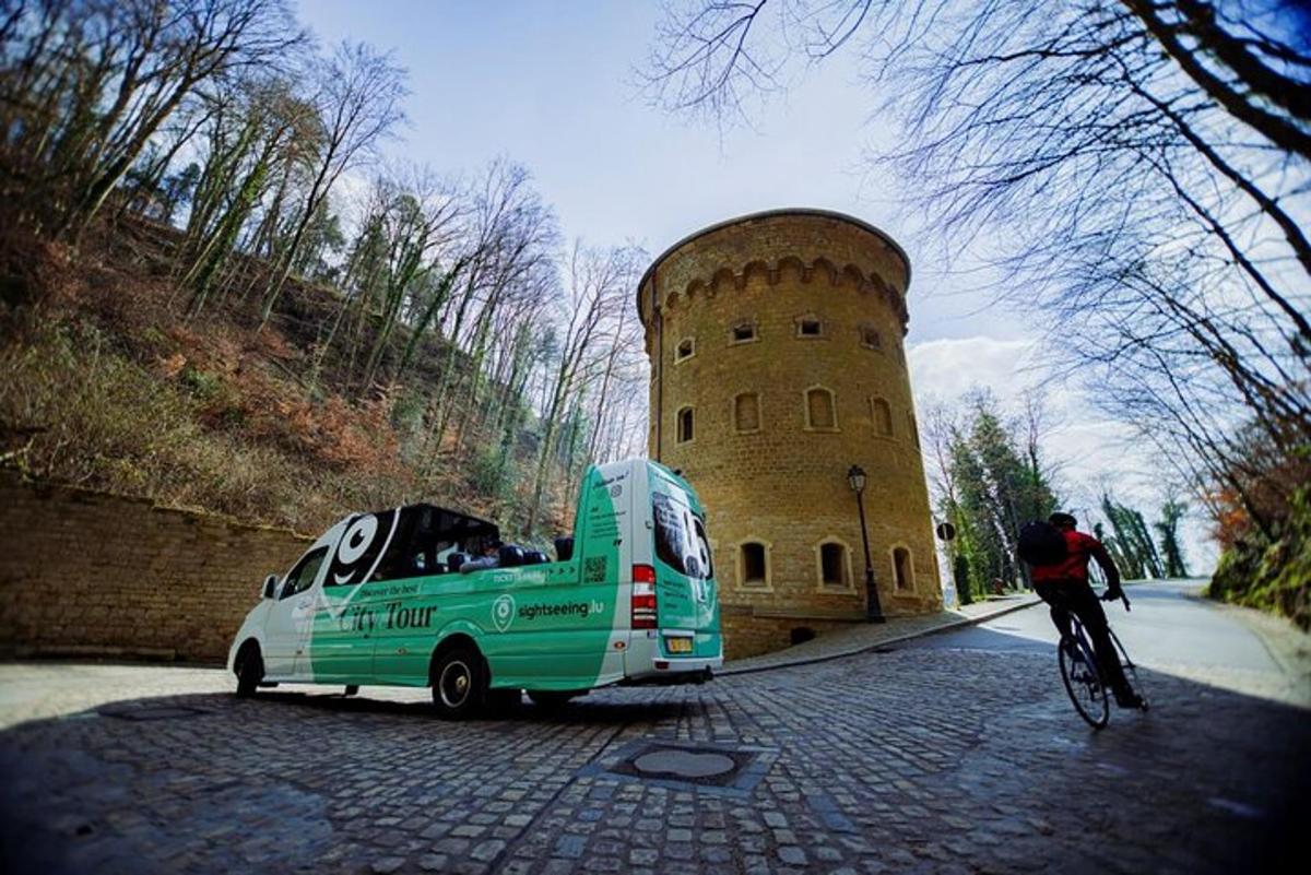 a man riding a bike next to a green van