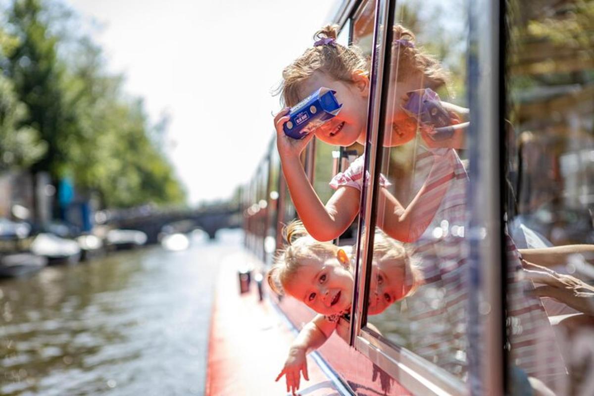 two little girls looking out the window of a boat