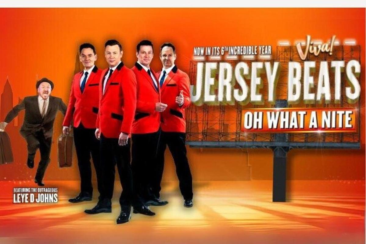 a group of men in red jackets on a stage