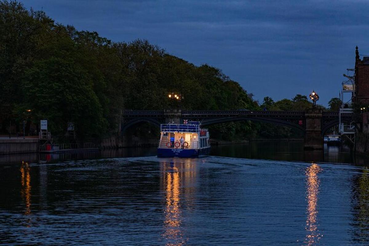 a boat traveling down a river under a bridge