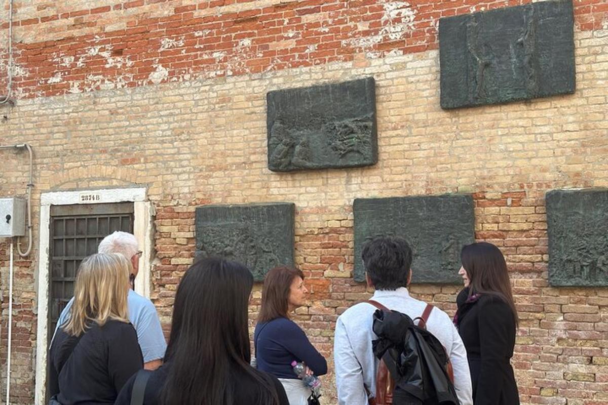 a group of people standing in front of a brick wall