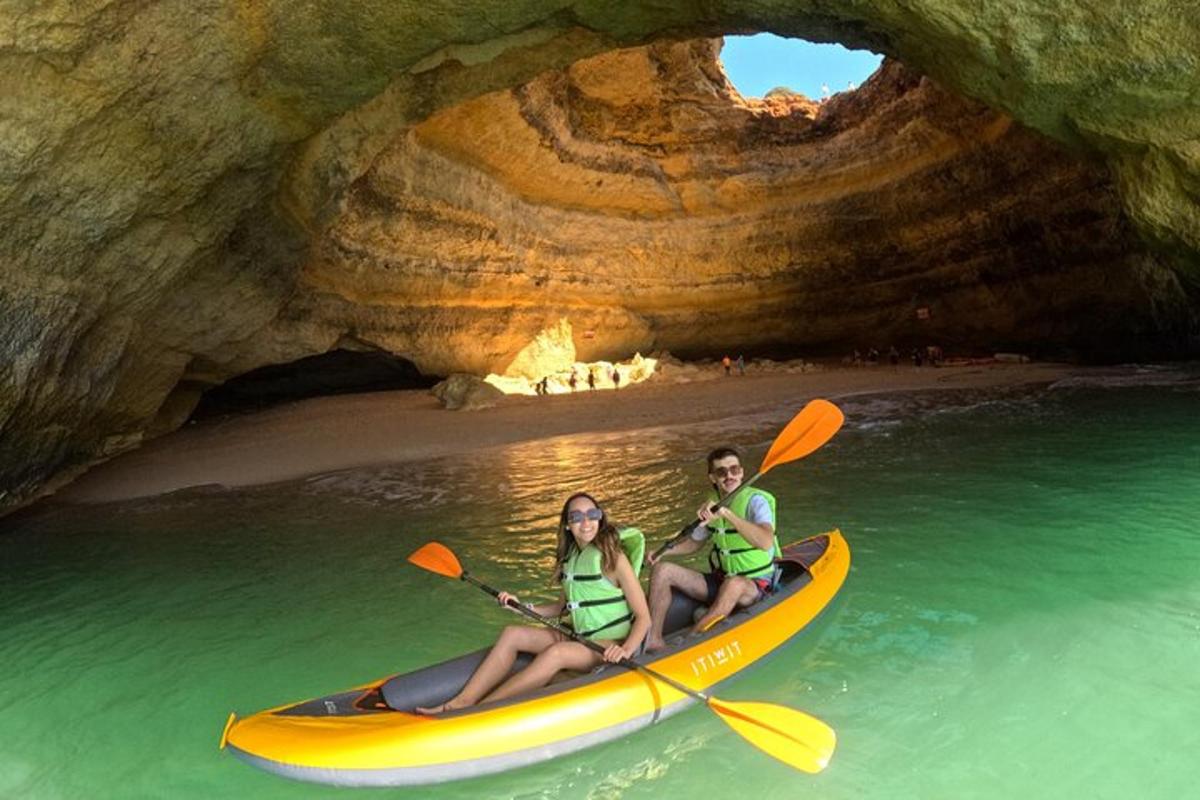 a man and woman in a kayak in a cave