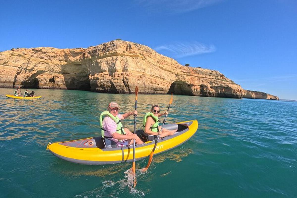 two people in a yellow boat in the water