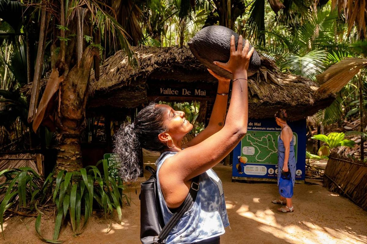 a woman is holding up a ball in the air