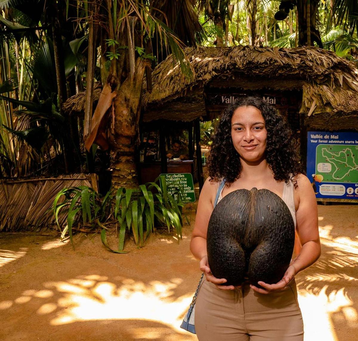 a woman is holding a plant in her hands