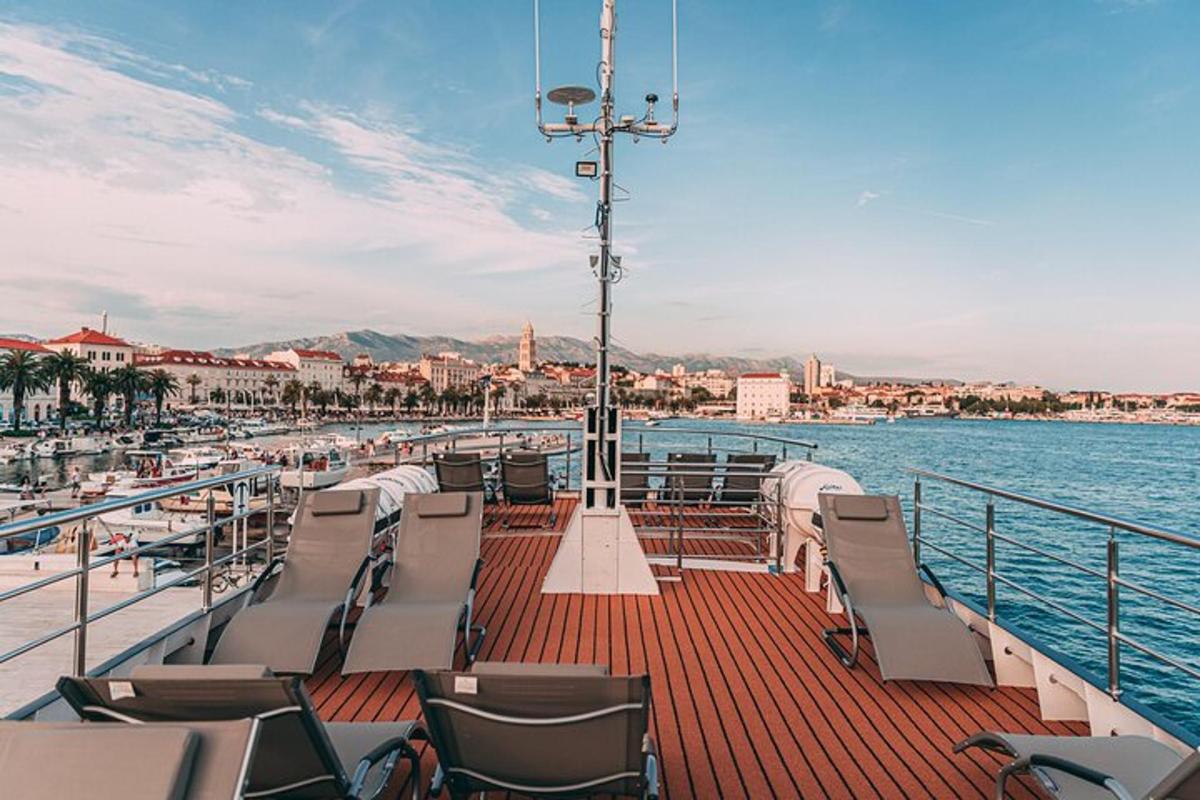 a boat in the water with chairs on the deck