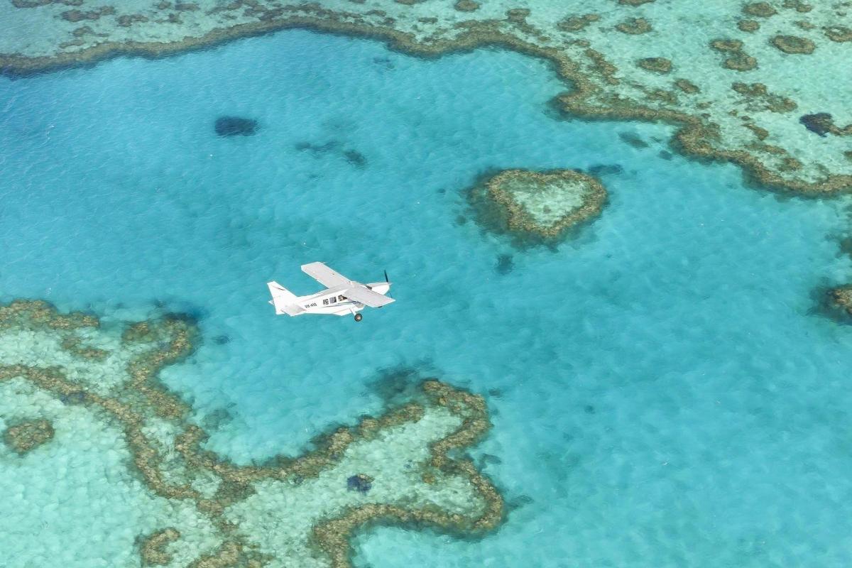 an airplane is flying over the ocean