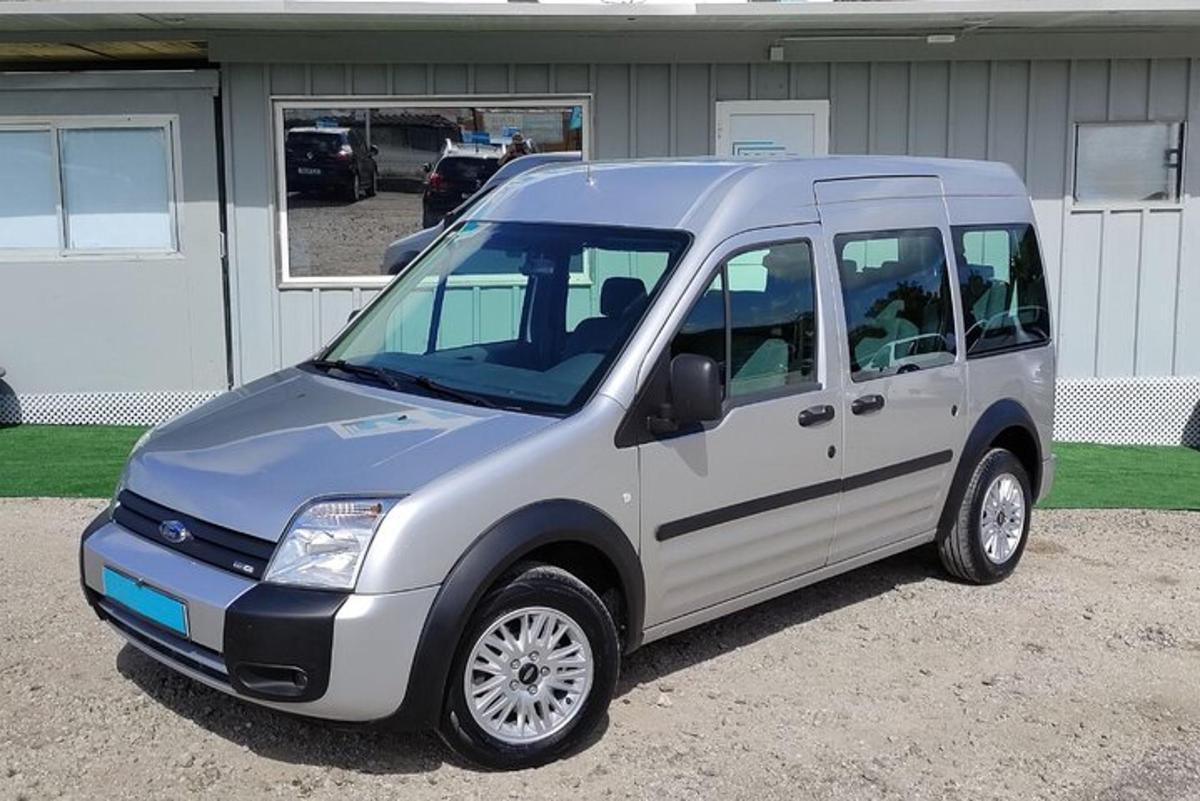 a silver van parked in front of a house