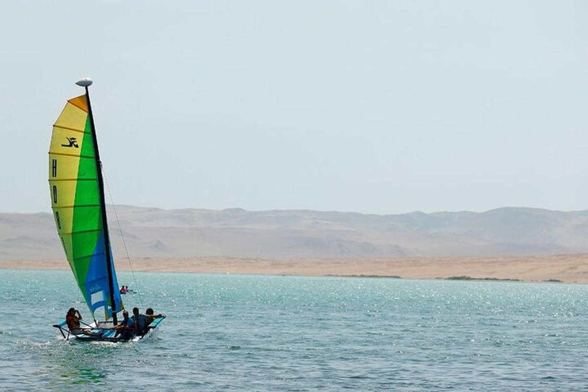 a group of people on a sail boat in the water