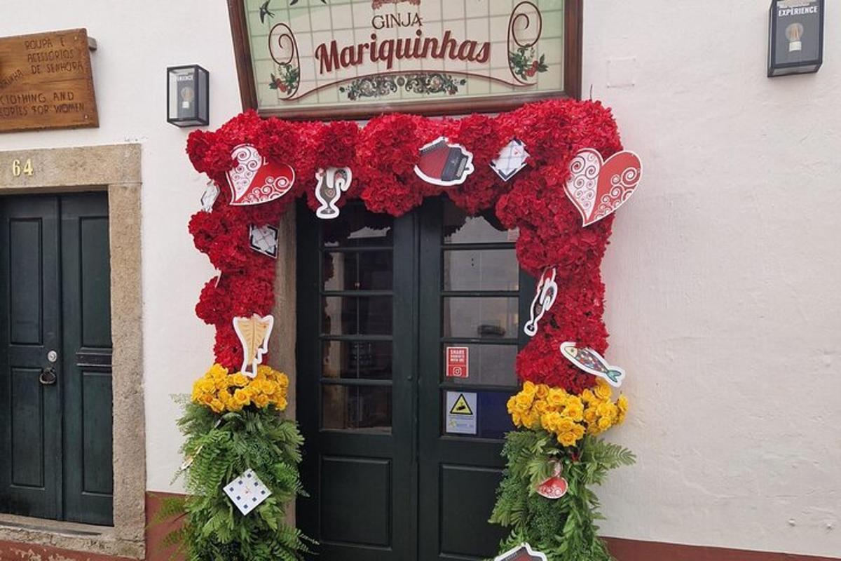 a door to a restaurant with red and yellow flowers
