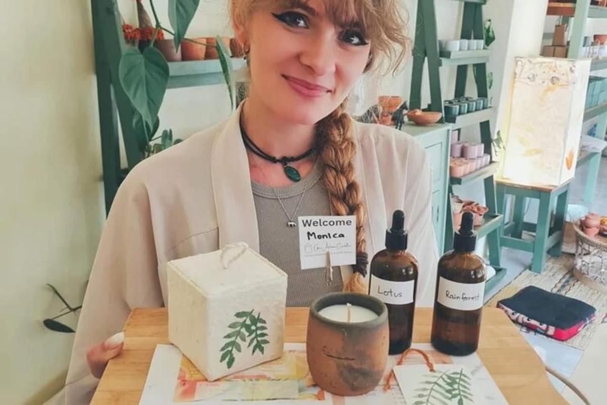 a woman sitting at a table with two bottles of wine