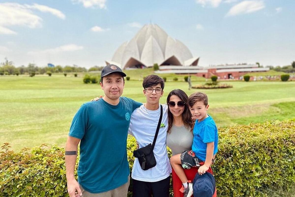 a family posing in front of the pyramids