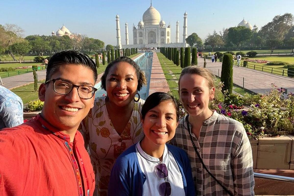 a family posing in front of the taj mahal