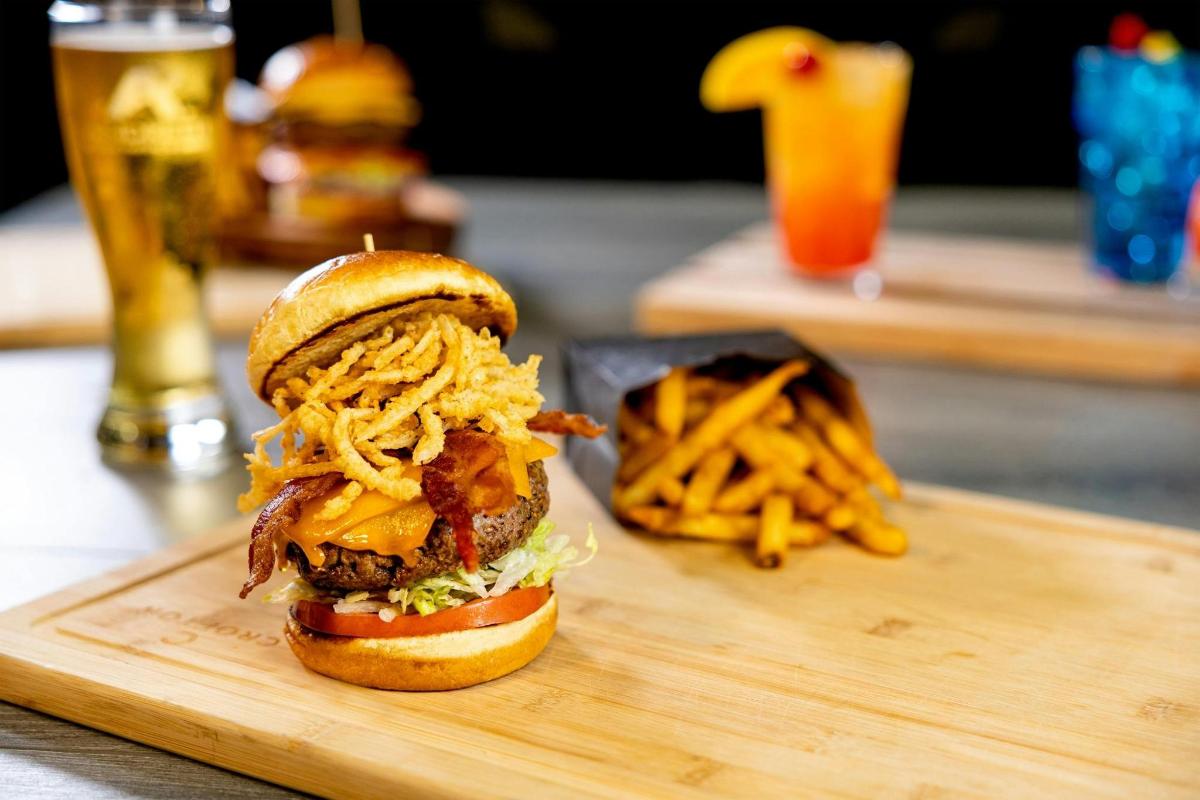 a sandwich and french fries on a wooden tray