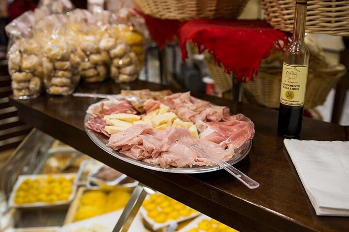 a table with a plate of food and a bottle of wine