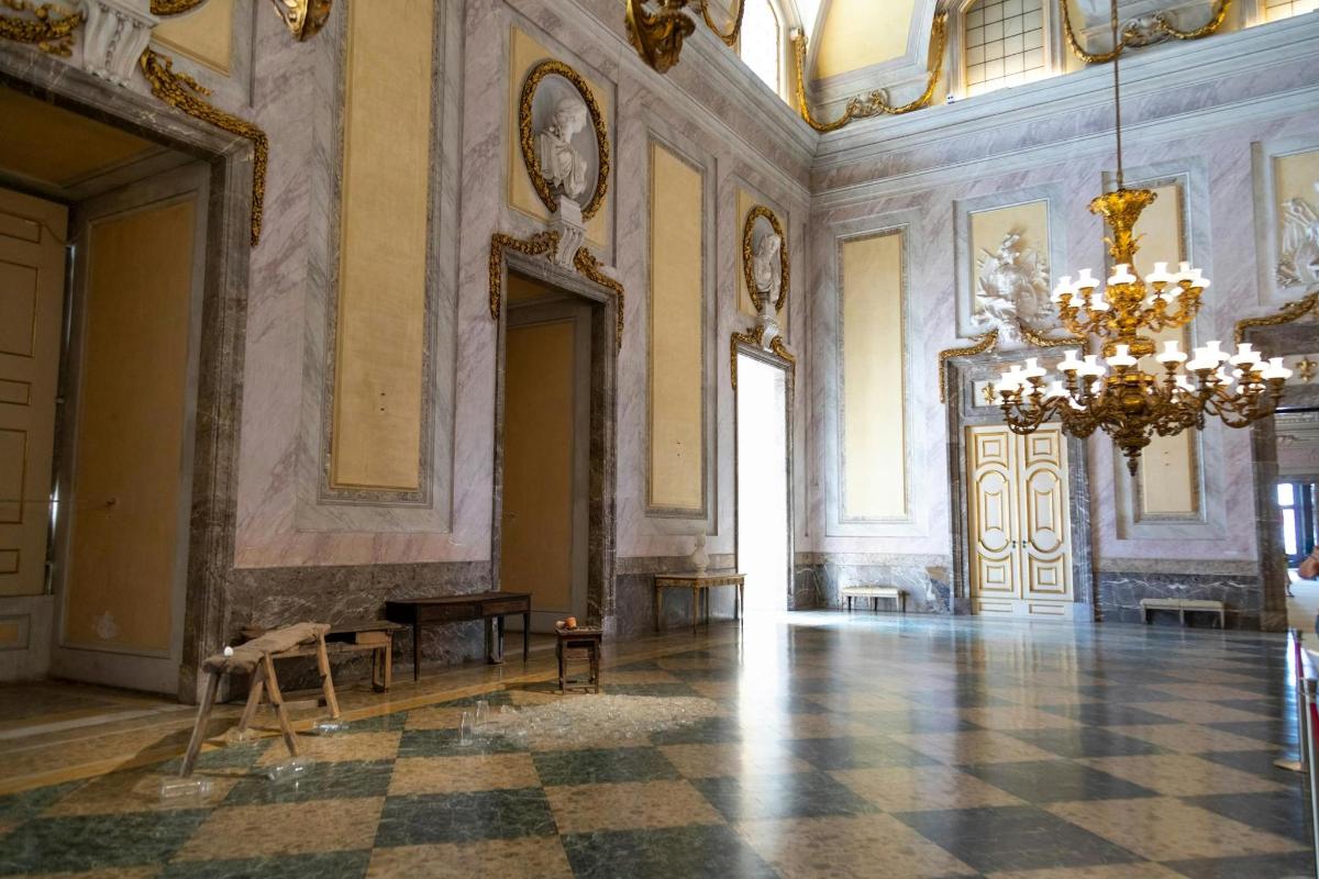 a large room with a chandelier and a checkerboard floor