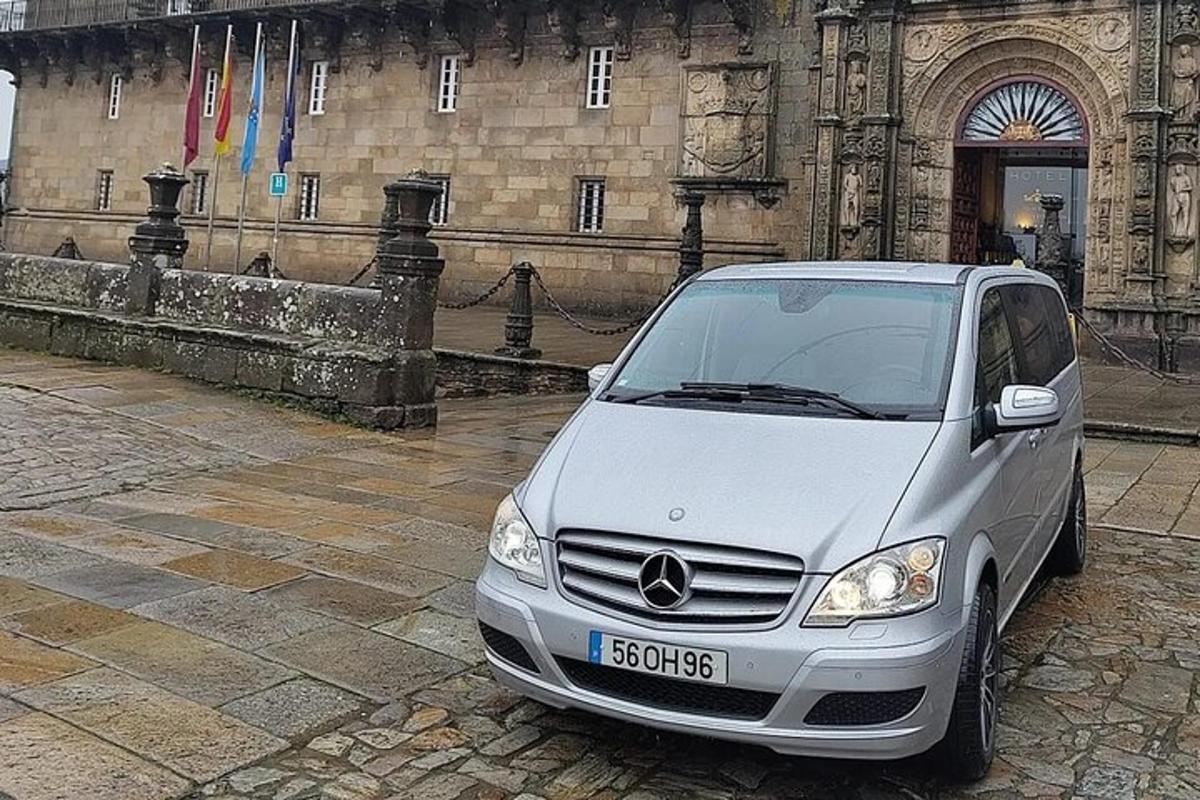 a silver car parked in front of a building