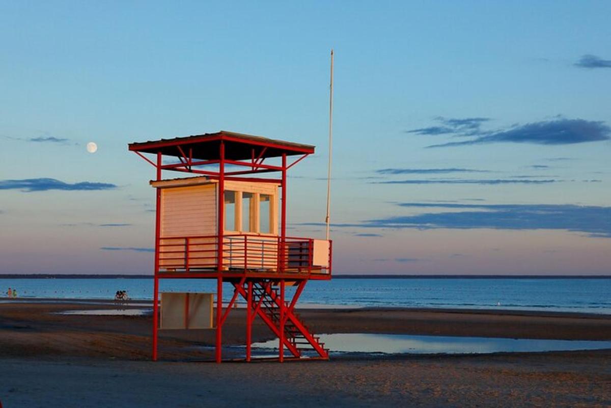a lifeguard tower on a beach with the ocean
