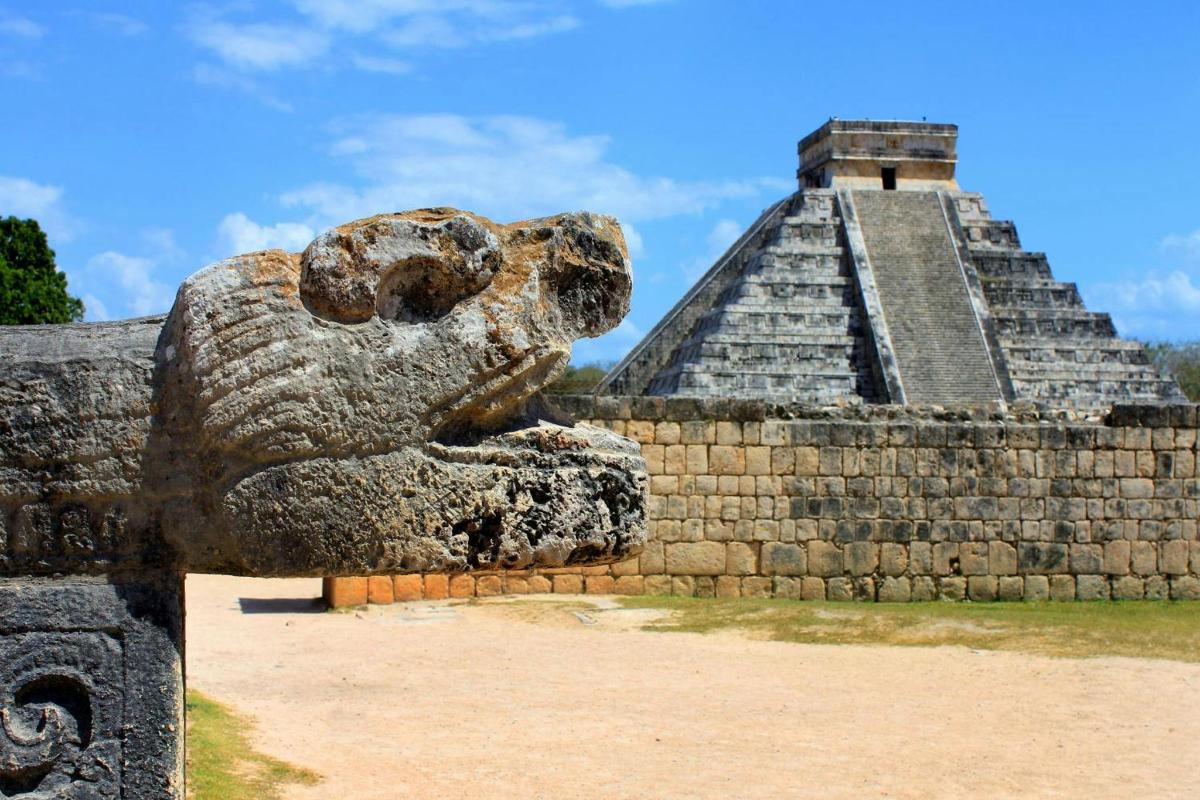 a statue of a bear in front of a pyramid