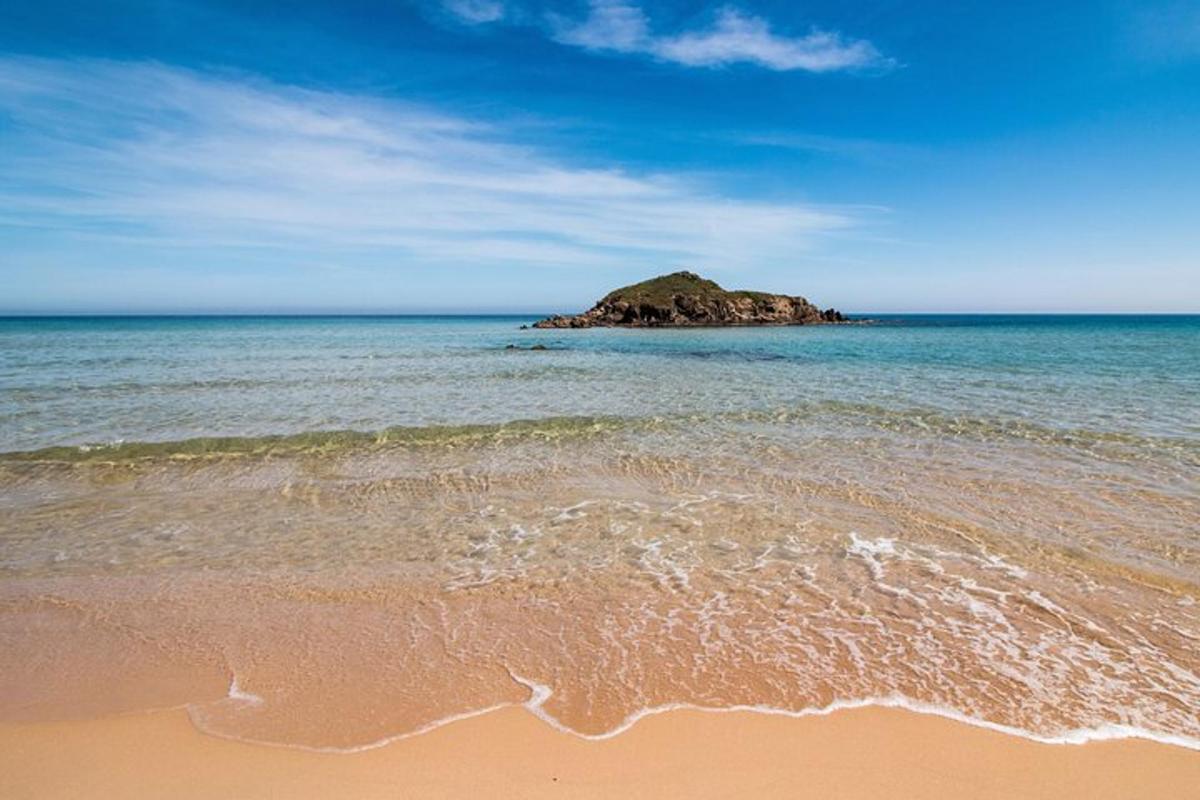 a beach with a small island in the ocean