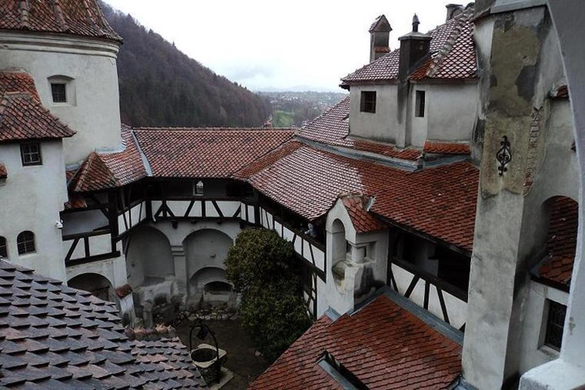an aerial view of a building with red tile roofs