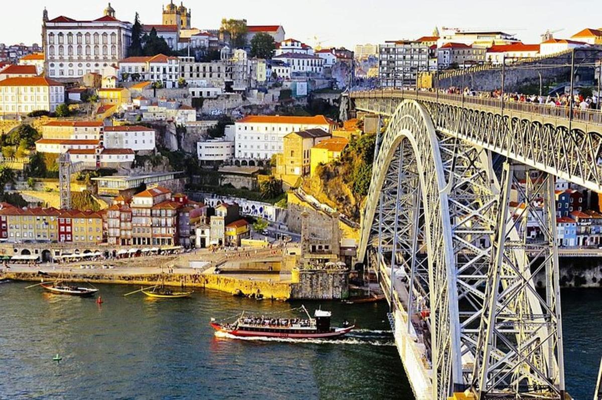 a bridge over a river with a city in the background
