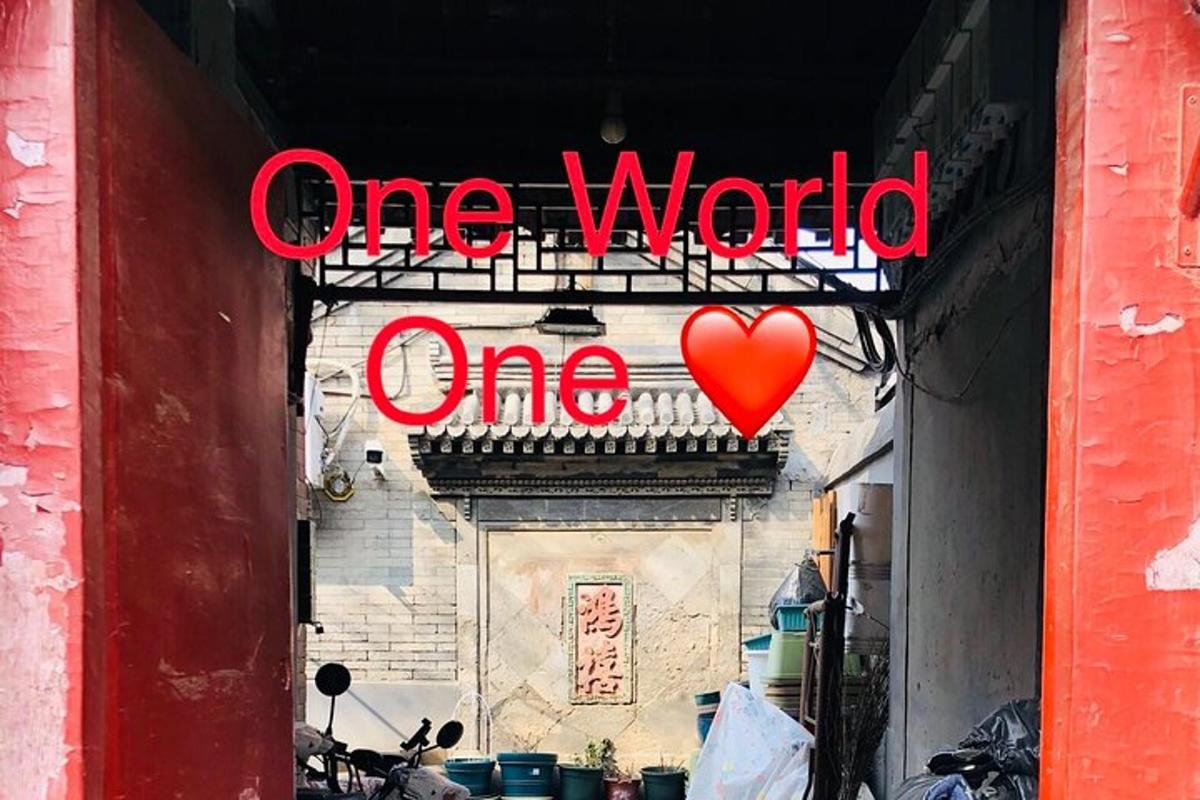 a one world sign on a building with a red heart