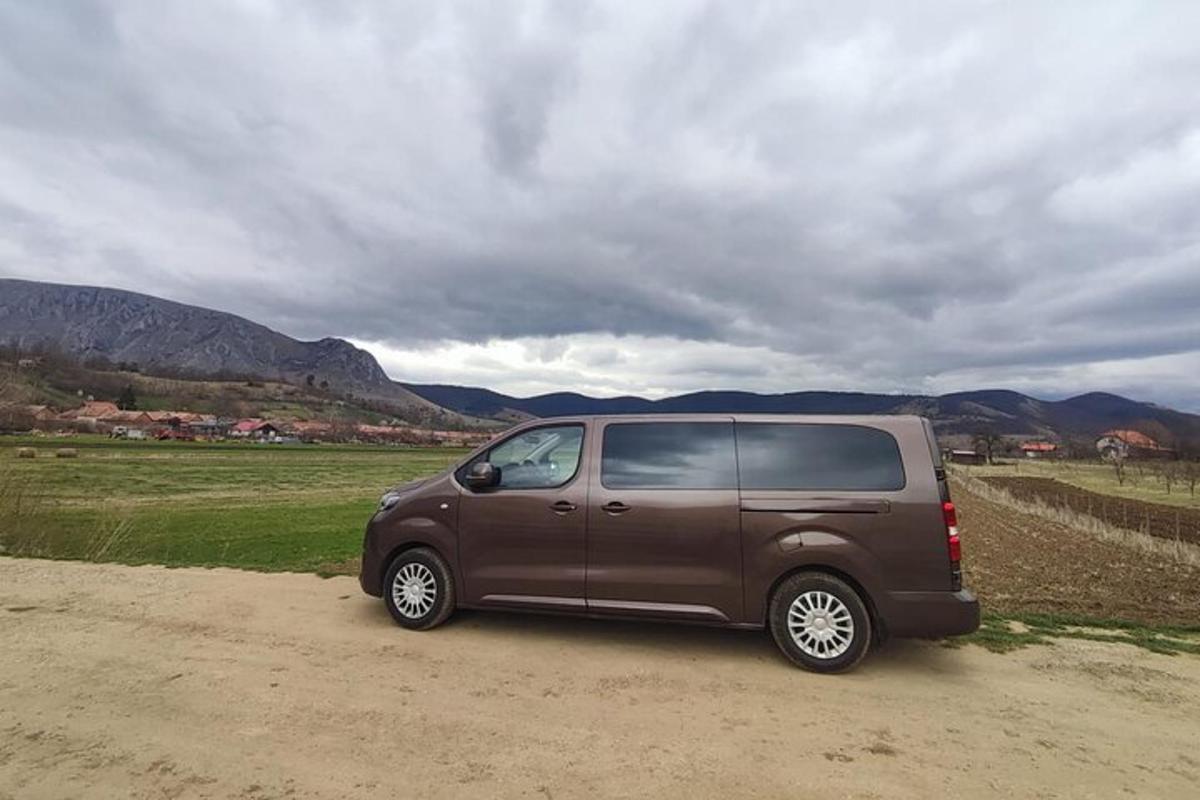 a van parked on a dirt road in a field