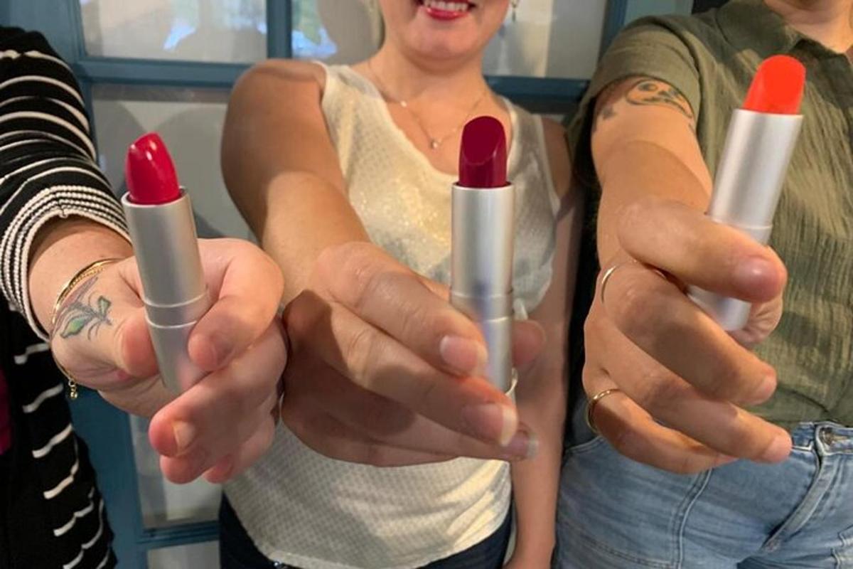 a woman holding two lipsticksticks in her hands