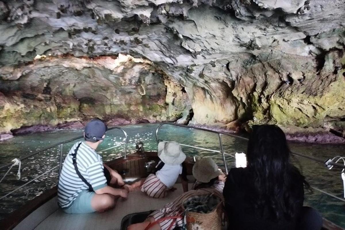 a group of people in a boat in a cave