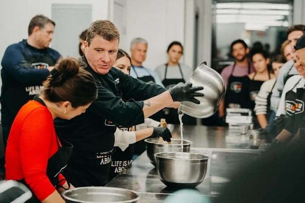 a man and a woman preparing food in a kitchen