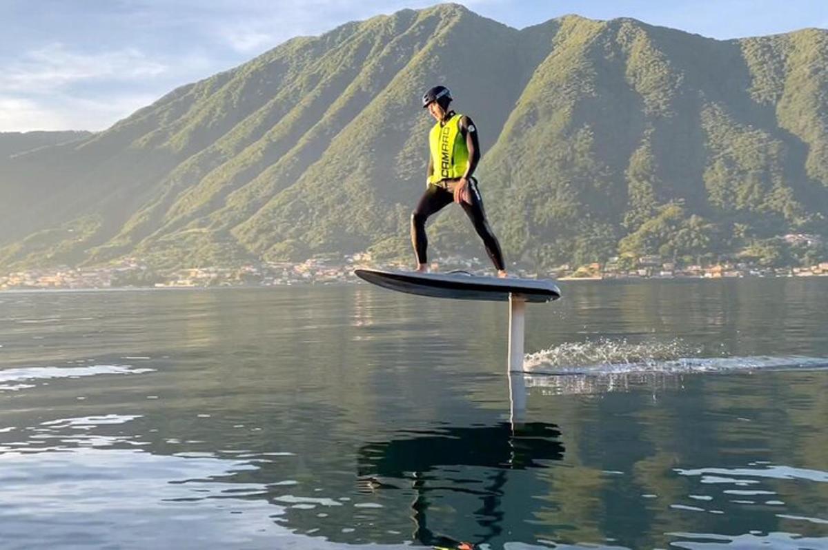 a man standing on a paddle board in the water