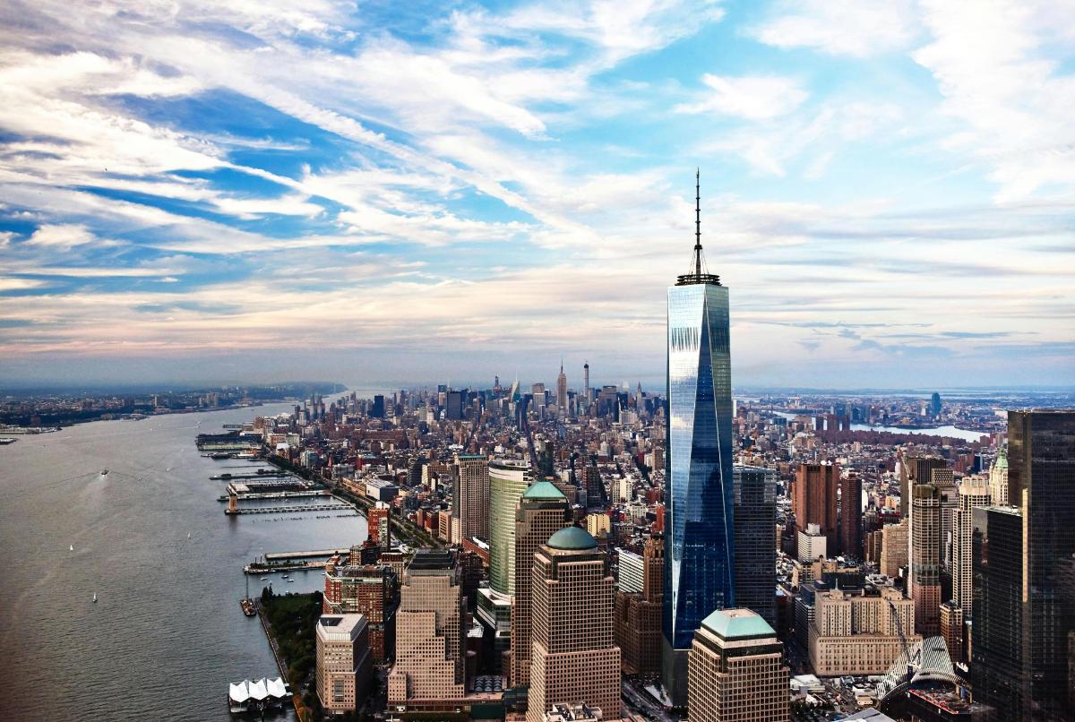 a view of a city with a tall skyscraper